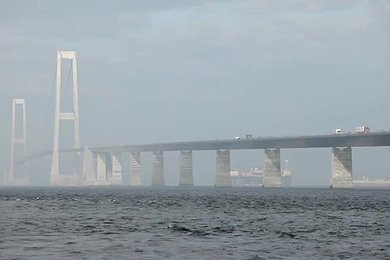 Pipelay Vessel Castoro Passes below the Great Belt Bridge in Denmark